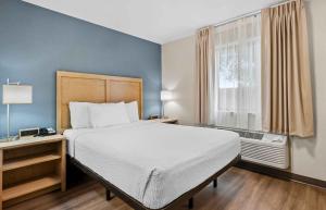 a bedroom with a large bed and a window at Extended Stay America Suites - Fort Wayne - North in Fort Wayne