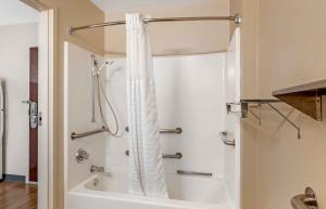 a shower with a white shower curtain in a bathroom at Extended Stay America Suites - Fort Wayne - North in Fort Wayne +31 photos
