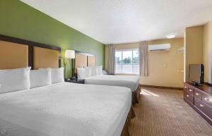 a hotel room with two beds and a television at Extended Stay America Suites - Sacramento - White Rock Rd in Rancho Cordova