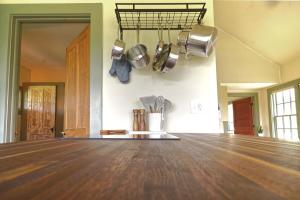 a kitchen with a wooden floor and pots and pans at Whitford House Cottage in Addison +23 photos