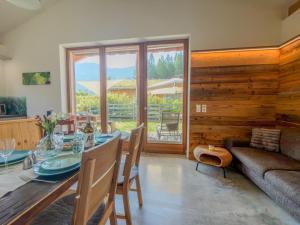 a dining room with a table and a couch at Warös 59 in Lake Pressegg