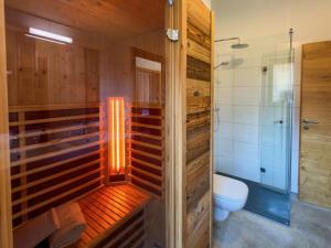 a bathroom with a shower and a toilet at Warös 59 in Lake Pressegg +44 photos