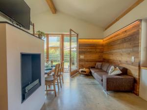 a living room with a couch and a television and a table at Warös 59 in Lake Pressegg