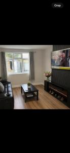 a living room with a couch and a flat screen tv at Hunters lodge in Blackpool