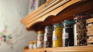a shelf with jars of pickles on it at Hiša Vasenka in Laze v Tuhinju +27 photos
