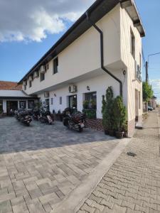 a group of motorcycles parked outside of a building at Casa Lipianu in Târgu Jiu
