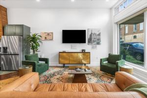 a living room with a couch and two chairs and a tv at Downtown Mobile Pets Ok Walkable Secure Parking in Mobile