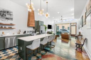 a kitchen with a large island with white counter tops at Downtown Mobile Pets Ok Walkable Secure Parking in Mobile