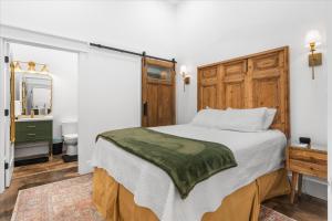 a bedroom with a large bed and a bathroom at Downtown Mobile Pets Ok Walkable Secure Parking in Mobile