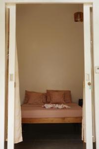 a bed in a room with a bed frame at Verde Bungalows Siargao in General Luna