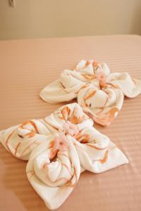 a group of white towels on a bed at Verde Bungalows Siargao in General Luna