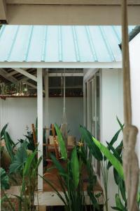 a porch with a blue awning on a house at Verde Bungalows Siargao in General Luna