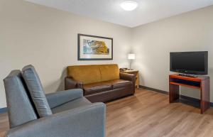 a living room with a couch and a television at Extended Stay America Suites - Fort Worth - Fossil Creek in Fort Worth