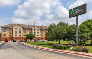 a sign for a hotel in front of a building at Extended Stay America Suites - Austin - Southwest in Austin