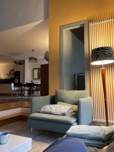 a living room with a couch and a table at Maison de charme 209m2 in Coray
