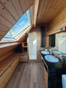 a bathroom with two sinks and a window at Maison de charme 209m2 in Coray