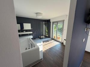 a bathroom with a tub and a sink in a room at Maison de charme 209m2 in Coray +38 photos