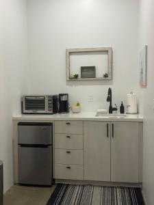 a kitchen with a microwave and a sink at Lazy G Ranch Casita 
