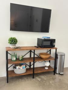 a television on top of a shelf with a microwave at Lazy G Ranch Casita 
