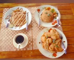 a table with plates of food and a cup of coffee at Zena Cottage in Ende