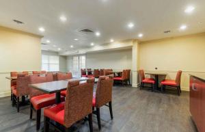 a conference room with tables and red chairs at Extended Stay America Suites - Columbia - Northwest Harbison in Harbison
