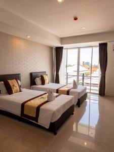 three beds in a room with a large window at Retreat Resort Pattaya in Nong Prue +113 photos