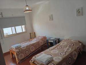 a room with two beds and a window at Casa Rodas in Goya