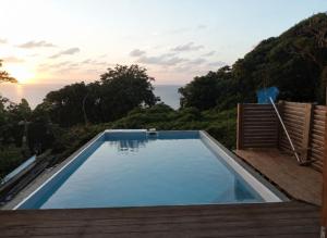 a swimming pool with a view of the ocean at VillaBadlou "Lodge Ti-Kaco Vanille" in Trois-Rivières