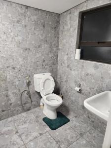a bathroom with a toilet and a sink at Hanca's Place in Parkwood