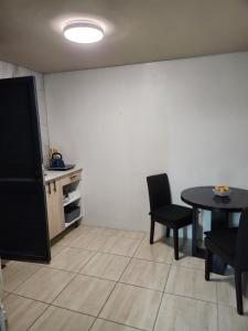 a living room with a table and chairs and a tv at Hanca's Place in Parkwood