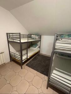 a small room with bunk beds in a attic at Welcome Home in Piaseczno