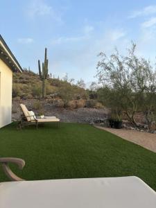 a lawn with a table and a bench on it at Lazy G Ranch Casita 