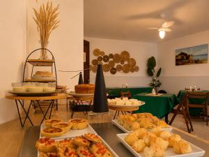 a buffet with various pastries and pies on a table at Pousada Bella Boipeba in Ilha de Boipeba