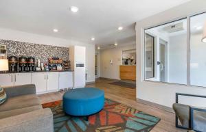 a living room with a couch and a blue stool at Extended Stay America Suites - Portland - East in Portland