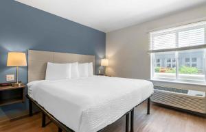 a bedroom with a large bed and a window at Extended Stay America Suites - Portland - East in Portland