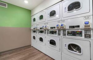 a row of washing machines in a laundry room at Extended Stay America Suites - Portland - East in Portland