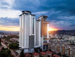 a large building with a nissan sign on top of it at Apartmani delux in Sarajevo