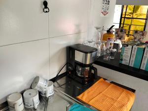 a coffee maker on a counter in a kitchen at Las Margaritas Cabin in Chinchiná