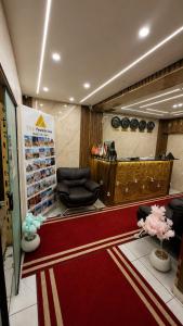 a lobby with a waiting room with a red carpet at Leeda Pyramids View in Cairo