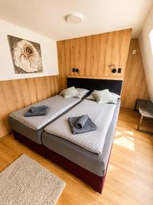 a bedroom with two beds with towels on them at SNOW LAKE Lipno in Lipno nad Vltavou +68 photos