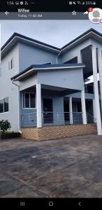 a large white house with a driveway in front of it at Fairview Executive Suites in Bawalishi