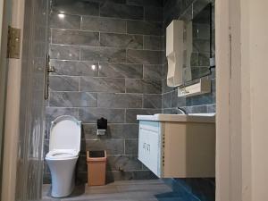 a bathroom with a toilet and a sink at Fairview Executive Suites in Bawalishi +10 photos