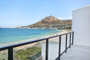 a balcony with a view of the beach and mountains at The Tide & Seek House in Cape Town