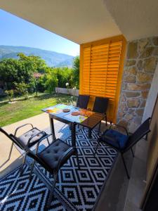 a patio with a table and chairs on a balcony at B&B Hidden gem Blagaj in Blagaj