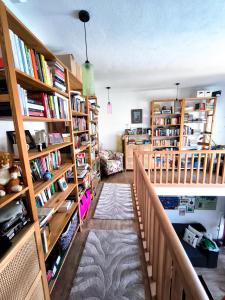 a library with wooden bookshelves and a hallway at B&B Hidden gem Blagaj in Blagaj