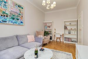 a living room with a couch and a table at Quiet luxury at the Royal Route in Warsaw in Warsaw