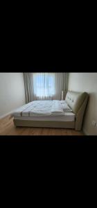 a large bed in a room with a window at "Private Room in New Luxury " Apartment in Ulaanbaatar