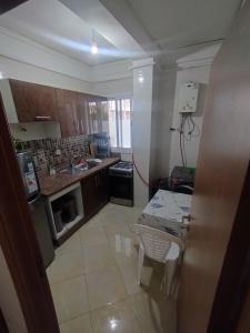 a small kitchen with a sink and a stove at Comp al Farah in Tangier