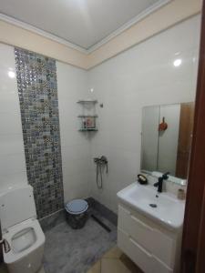 a bathroom with a toilet and a sink and a shower at Comp al Farah in Tangier