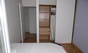 an empty room with a bed and a closet at Kirollos in Montlhéry